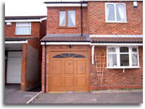 A two story extension with garage below and bedroom above